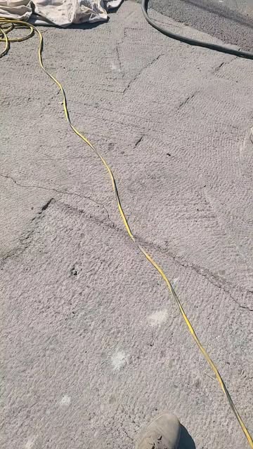 Freshly poured concrete surface being finished at the manufacturing facility